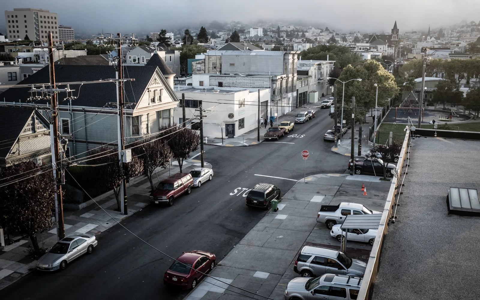 Foggy morning view of a suburban neighborhood showing typical residential development